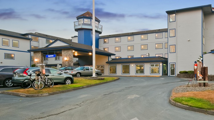 From of hotel with parking lot